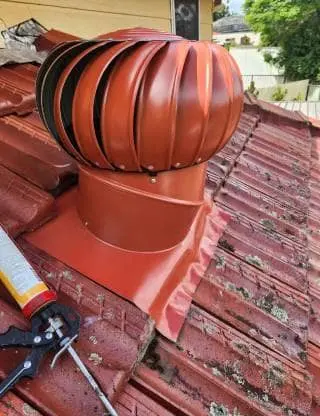 a whirlybird installed on a roof